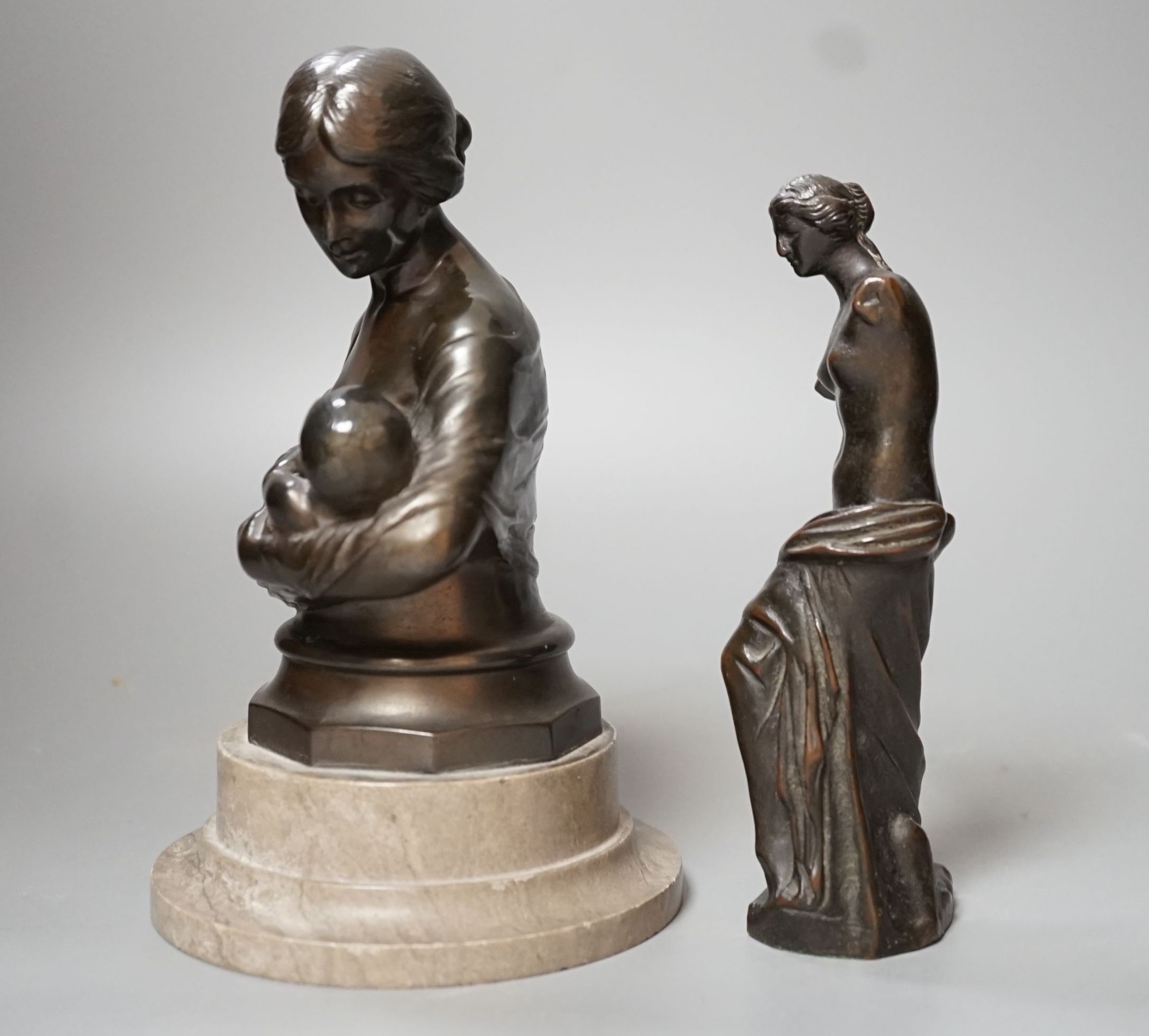 A bronze figure of the Venus de Milo, 16cm, together with another bronze bust of mother and child on plinth base, 19cm